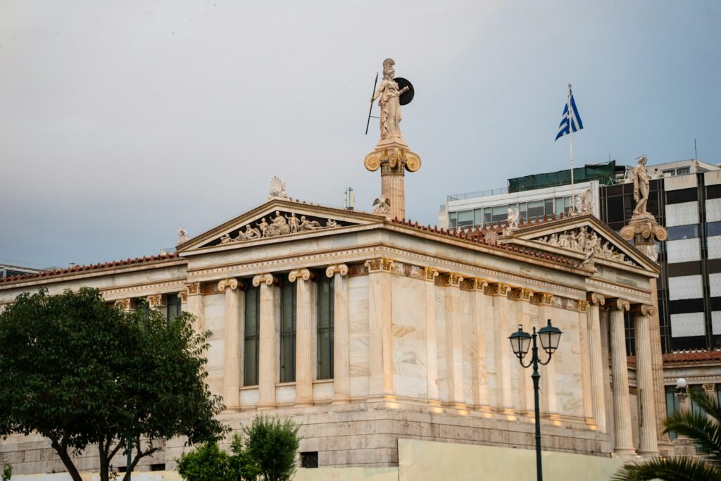 Neoclassical building with a statue and greek flag
