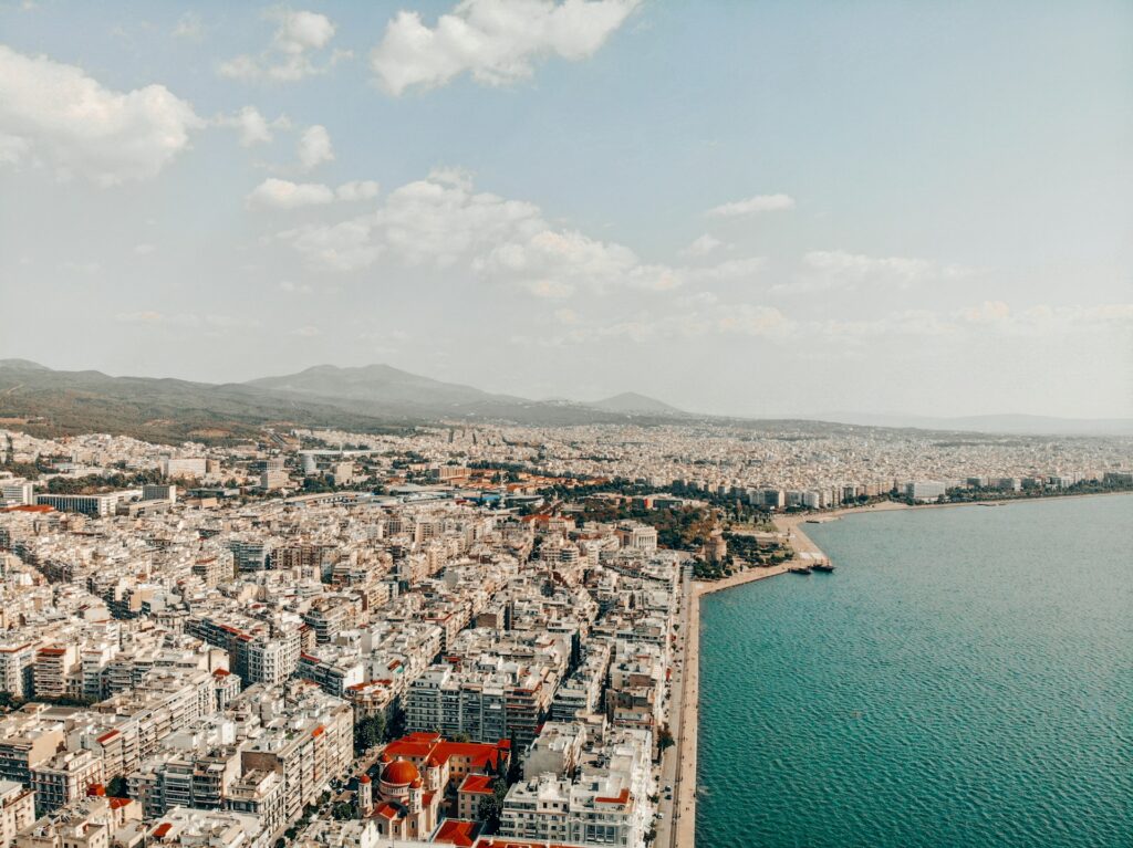 Photo by <a href="https://unsplash.com/@_miltiadis_?utm_source=unsplash&utm_medium=referral&utm_content=creditCopyText">Miltiadis Fragkidis</a> on <a href="https://unsplash.com/photos/an-aerial-view-of-a-large-city-next-to-a-body-of-water-svzogdtdyl0?utm_source=unsplash&utm_medium=referral&utm_content=creditCopyText">Unsplash</a>